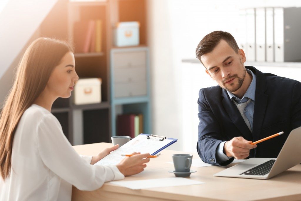 HR manager interviewing young man in office