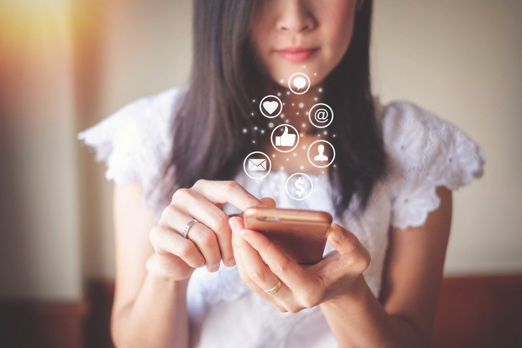 woman using social media on her phone