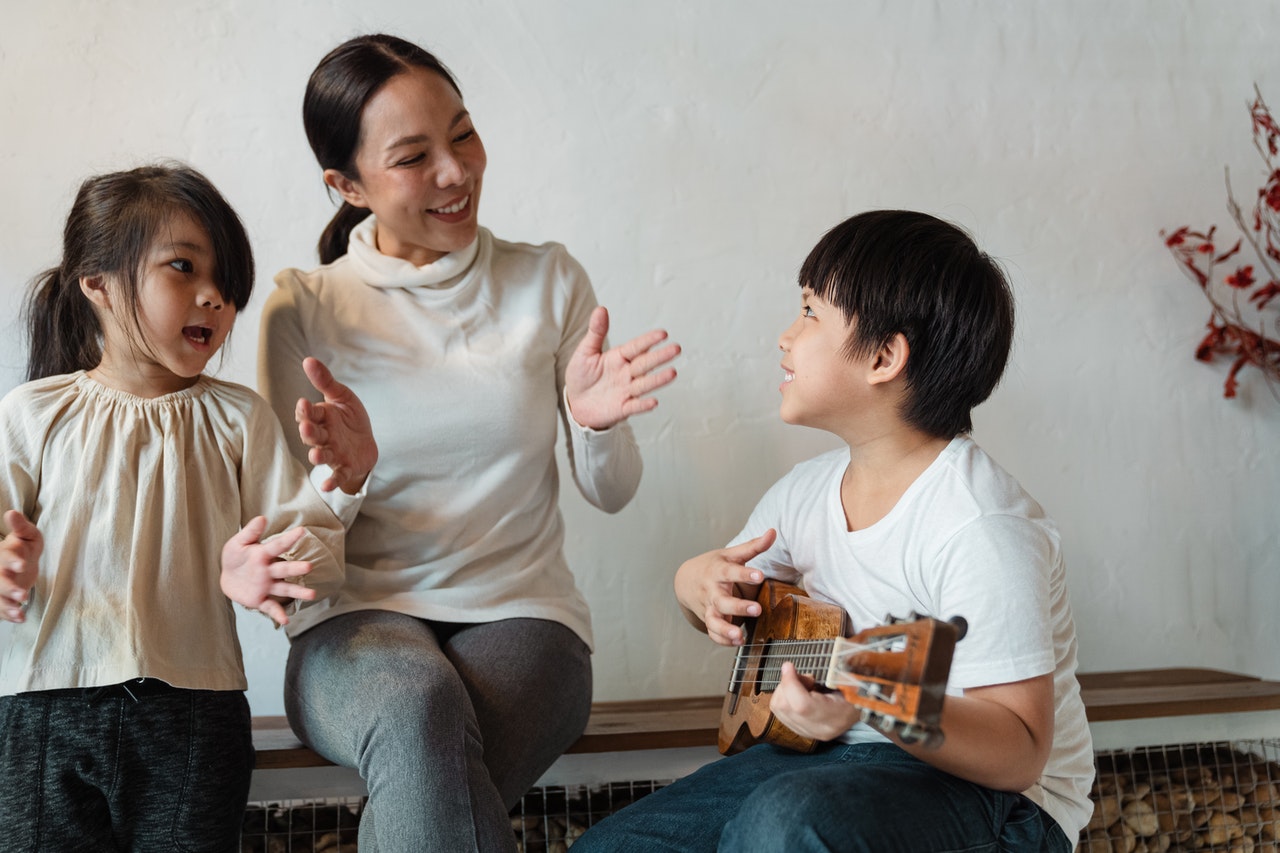 child playing a ukulele