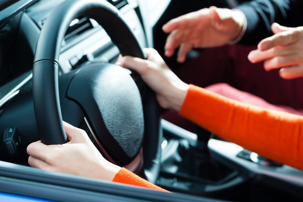 man guiding student driver