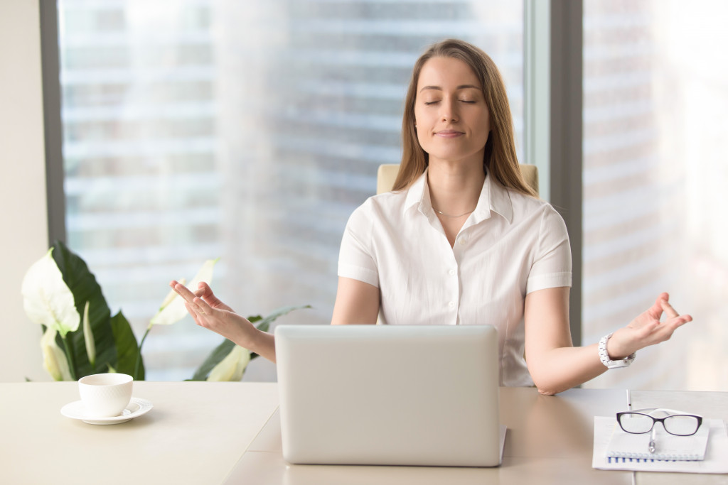 woman meditating in the workplace office 