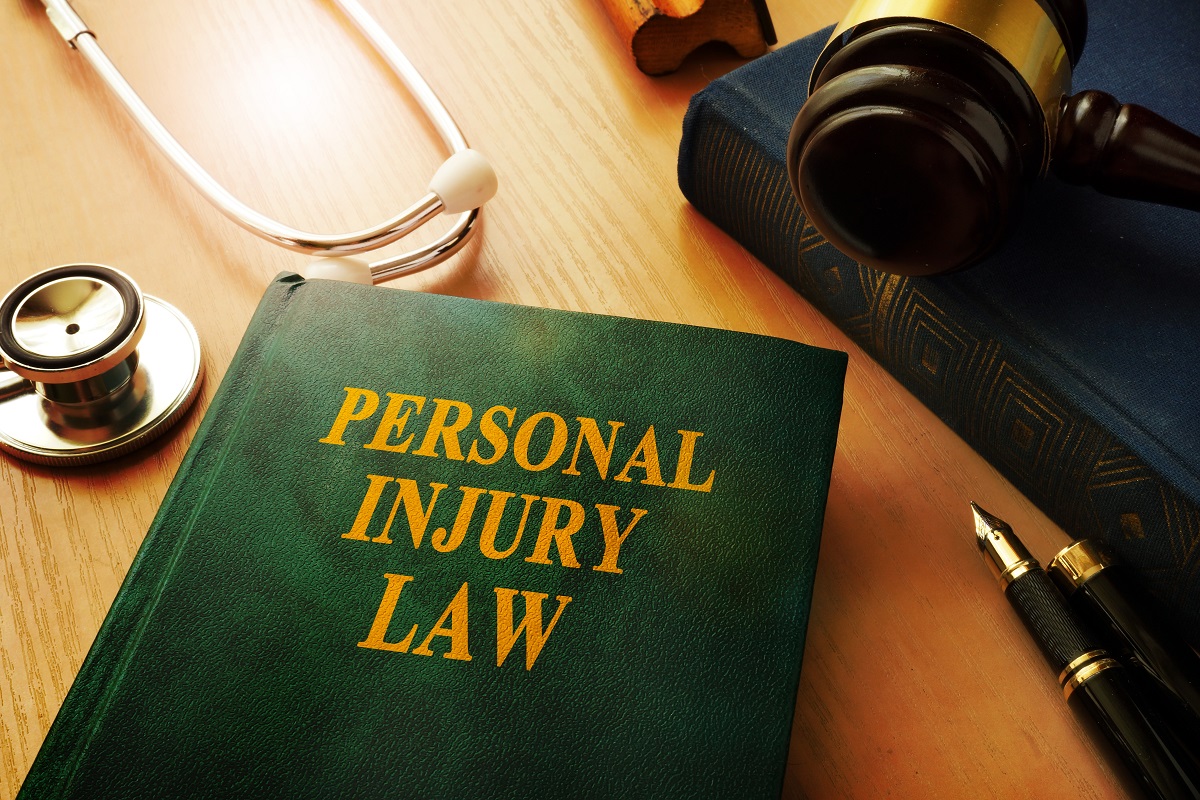 personal injury book in law at the table with stethoscope on the side