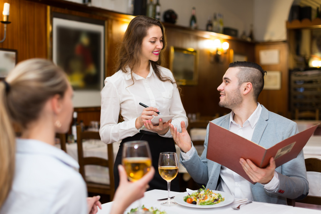restaurant waitress talking to male guest
