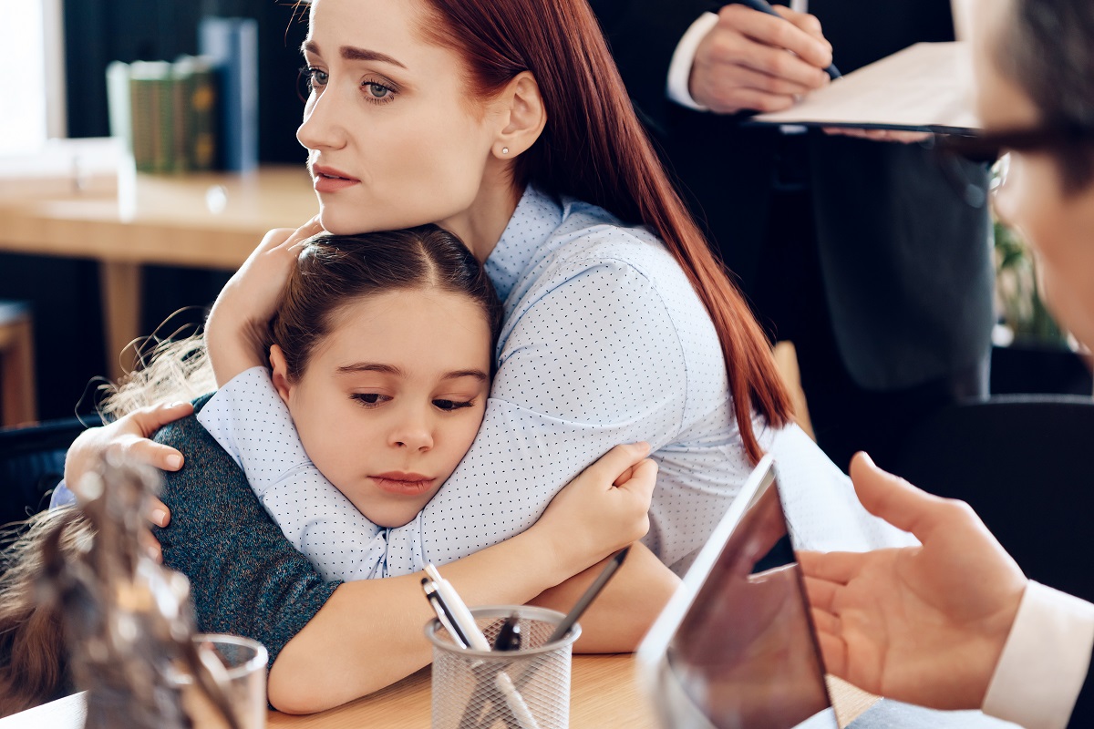 pretty little girl hugging her mom