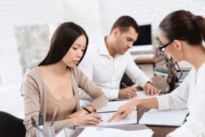 couple signing divorce papers