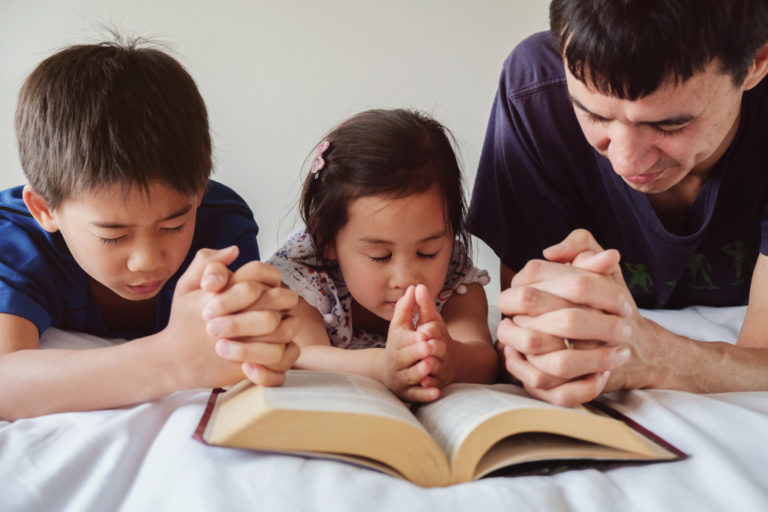 father and children praying