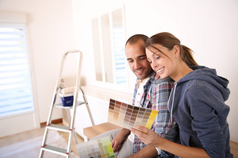 Couple in new house choosing color for walls
