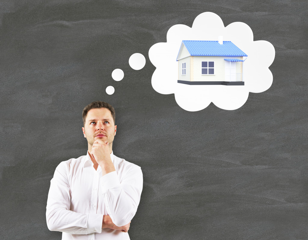 man thinking about buying a house