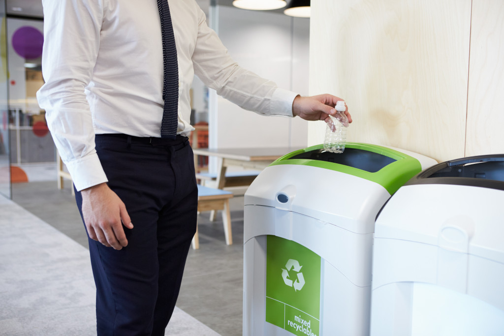 Segregating garbage in the office, a man throwing a water bottle