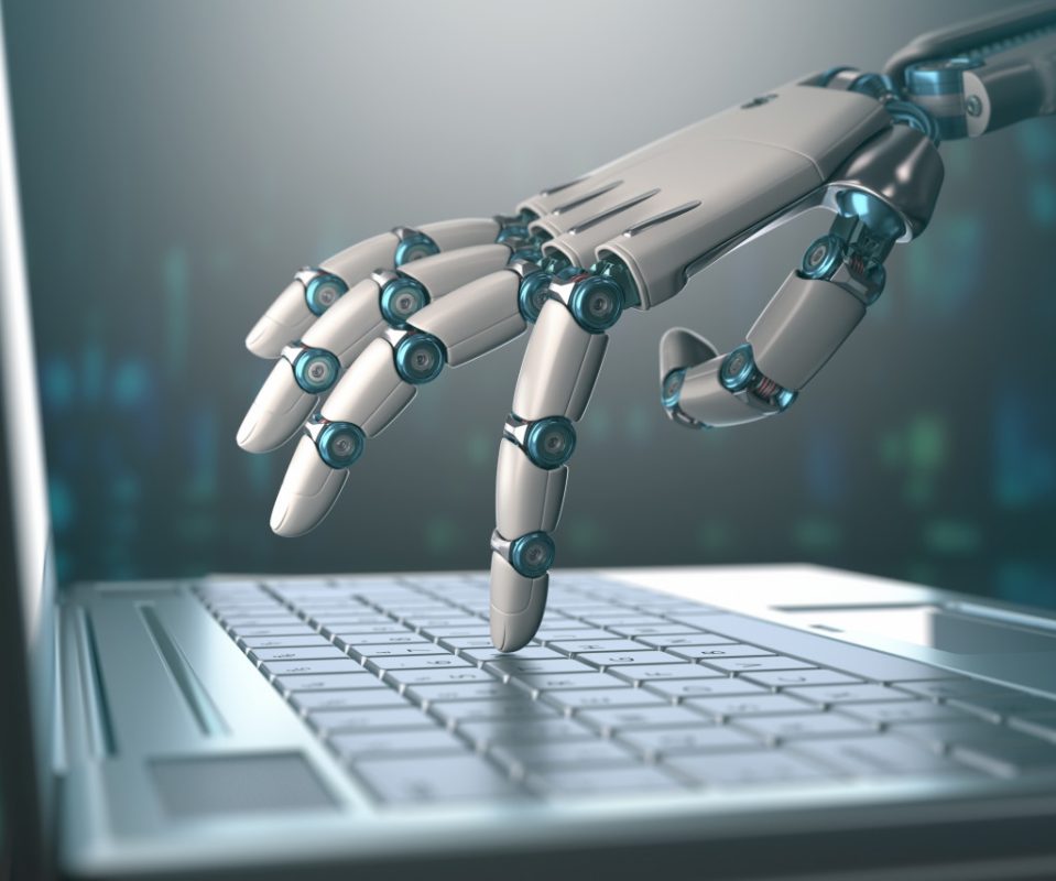 robotic hand pressing the laptop keyboard