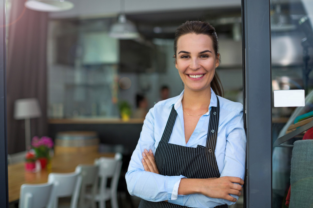 restaurant owner smiling at the entrance