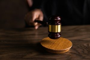 close-up of a judge's hand striking a gavel