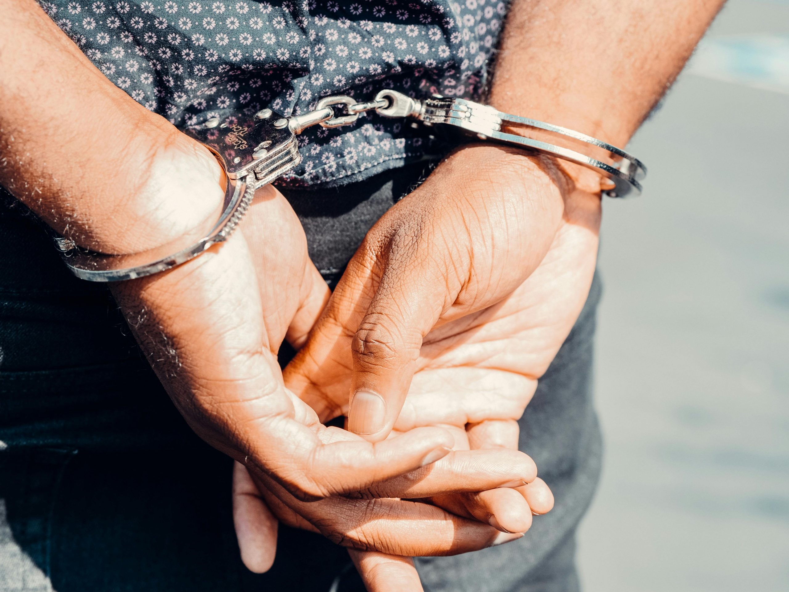 close-up of hands in handcuffs